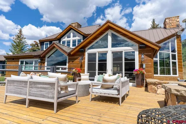 a front view of a house with patio furniture and garden