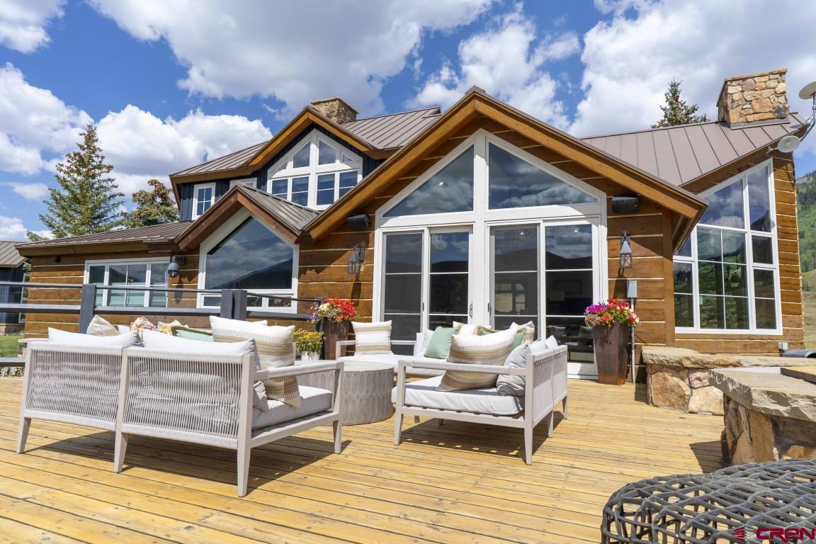 7 Moon Ridge Lane Crested Butte, CO 81224 - Photo 8 of 44 a front view of a house with patio furniture and garden