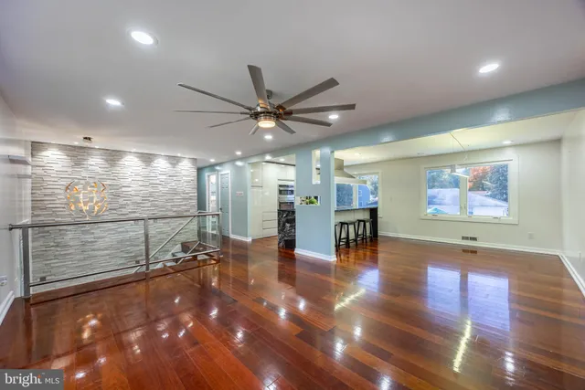 a view of a projector room with wooden floor and a ceiling fan