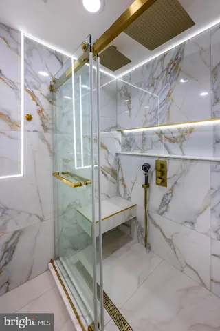 a bathroom with a bathtub and shower