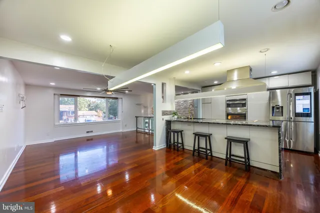a view of a room with furniture and wooden floor
