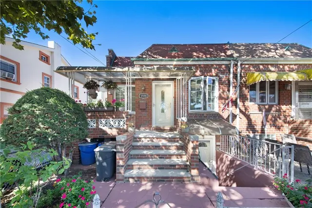 a view of a building with a garden and potted plants