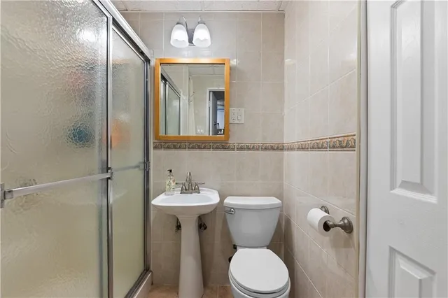 a bathroom with a toilet sink and shower