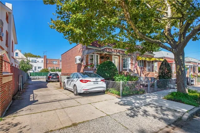 a white house that has a tree in front of it