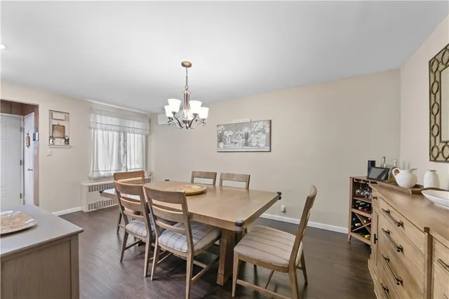 a view of a dining room with furniture and chandelier