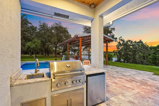 a bedroom with a bed a flat screen tv and a window