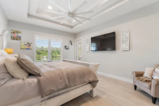 a view of a balcony with wooden floor and iron fence