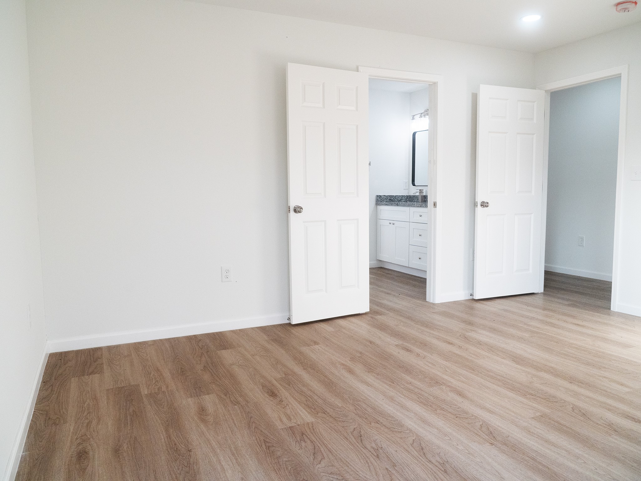 37 Road 5102, Unit L Cleveland, TX 77327 - Photo 11 of 29 a view of a room with wooden floor and a hallway