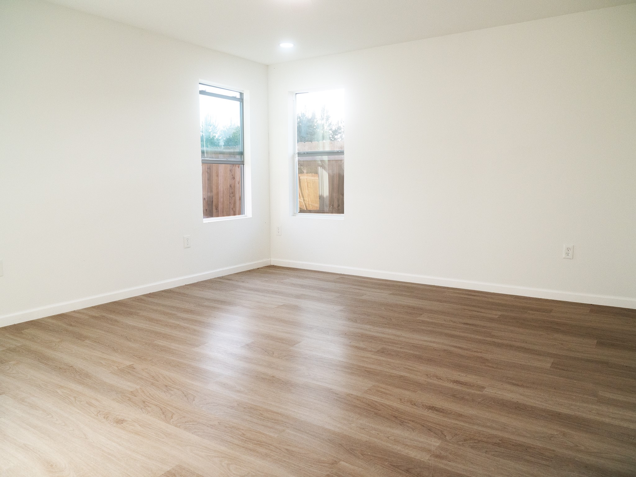 37 Road 5102, Unit L Cleveland, TX 77327 - Photo 12 of 29 an empty room with wooden floor and windows