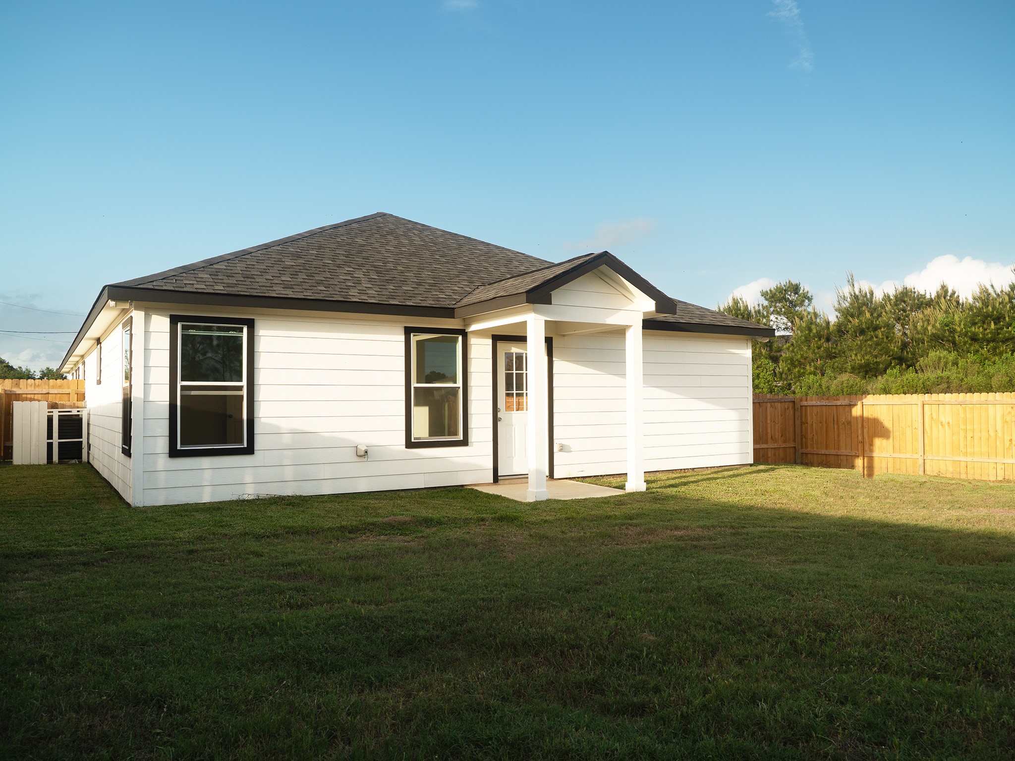37 Road 5102, Unit L Cleveland, TX 77327 - Photo 23 of 29 a front view of a house with a garden