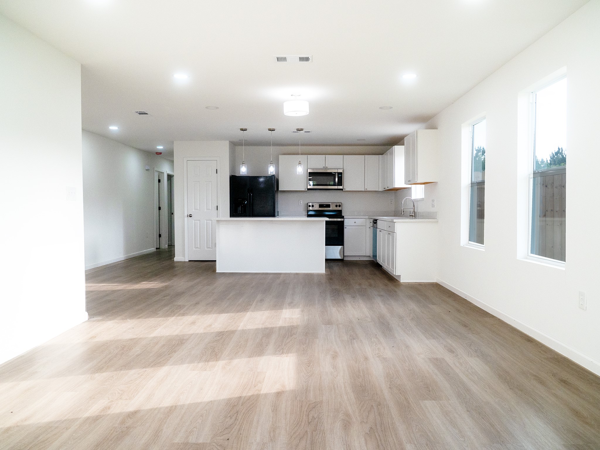 37 Road 5102, Unit L Cleveland, TX 77327 - Photo 4 of 29 a view of a kitchen with furniture and wooden floor