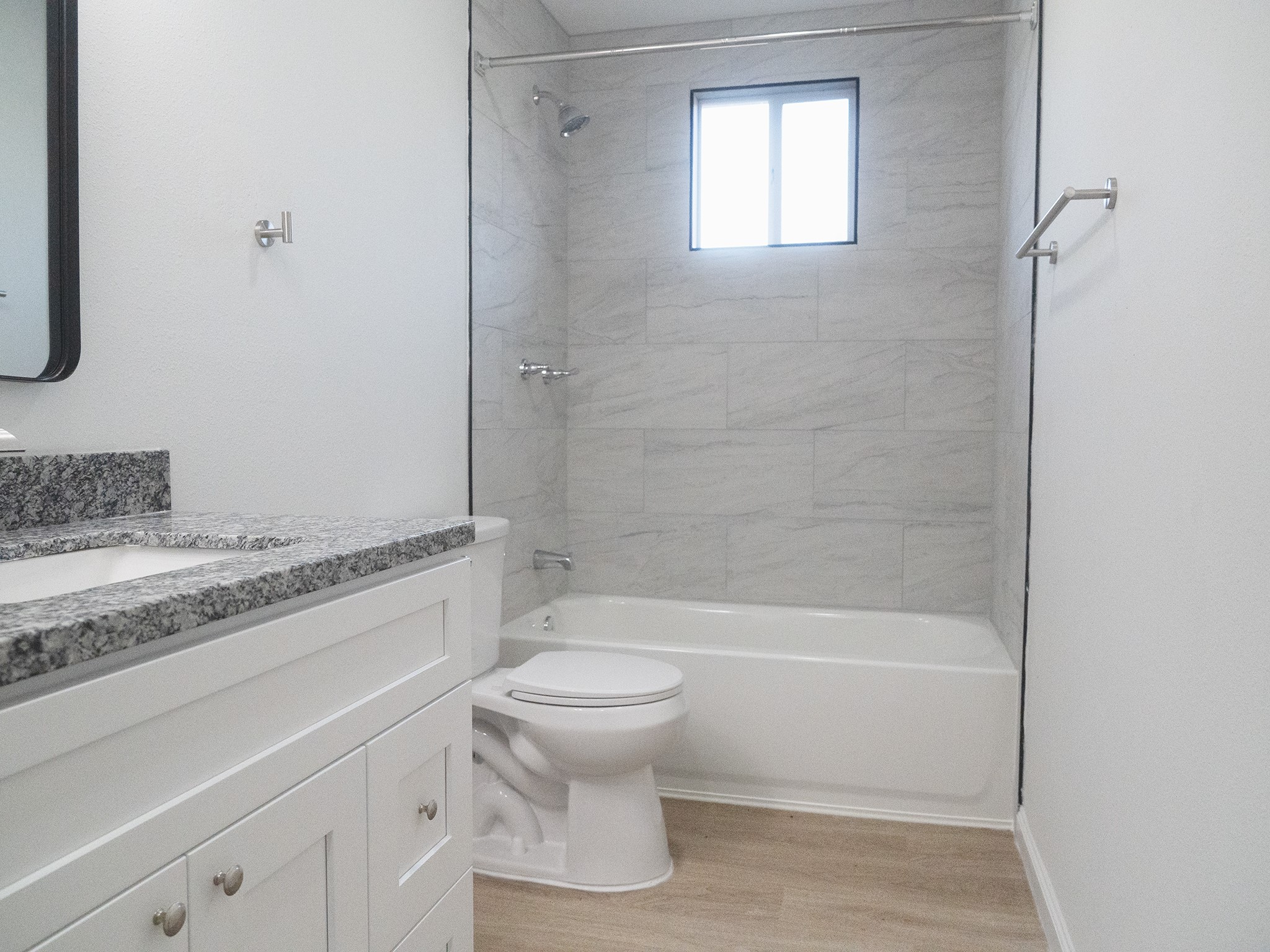 37 Road 5102, Unit L Cleveland, TX 77327 - Photo 6 of 29 a bathroom with a granite countertop toilet a sink and a bathtub