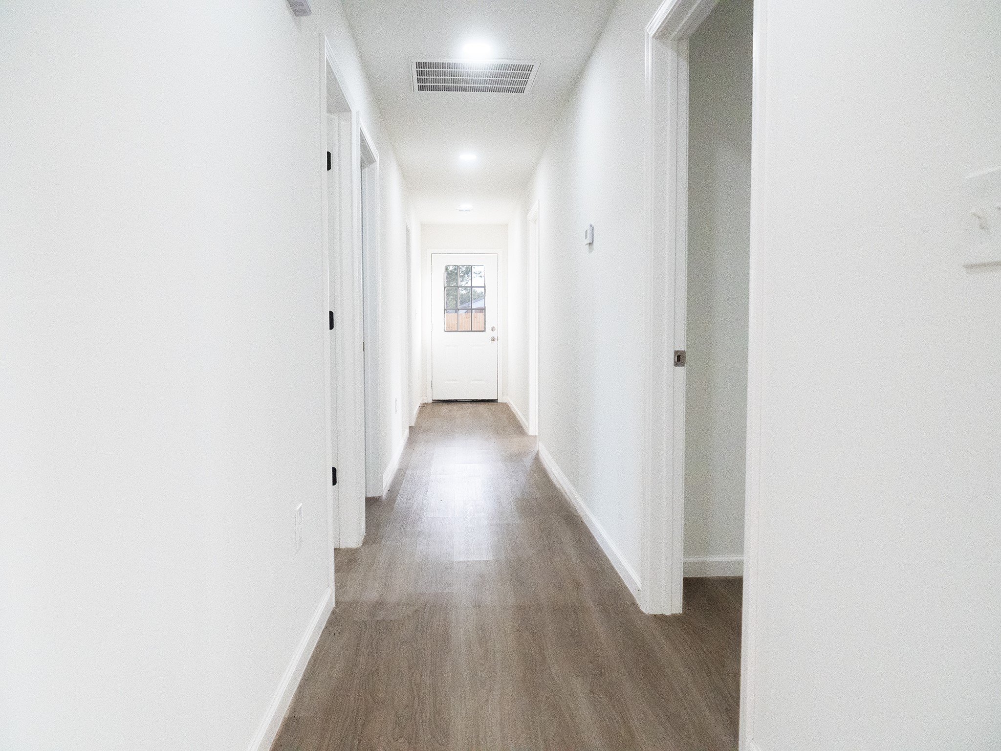 37 Road 5102, Unit L Cleveland, TX 77327 - Photo 10 of 29 a view of a hallway with wooden floor