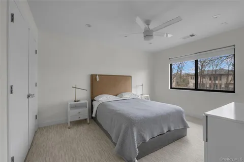 a bedroom with a bed and a painting on the wall