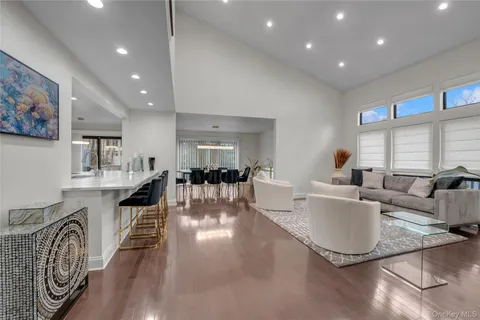 a living room with furniture a wooden floor and a large window