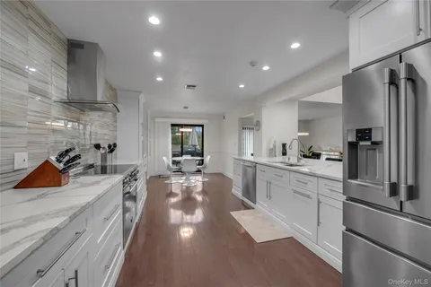 a large kitchen with stainless steel appliances lots of counter space and a sink