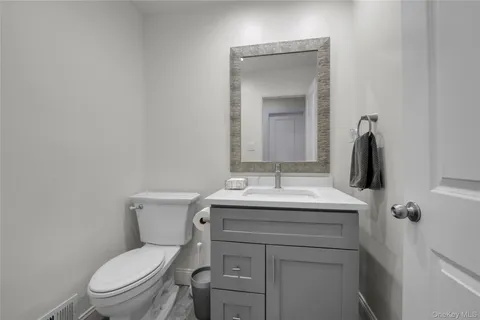 a bathroom with a toilet sink and mirror