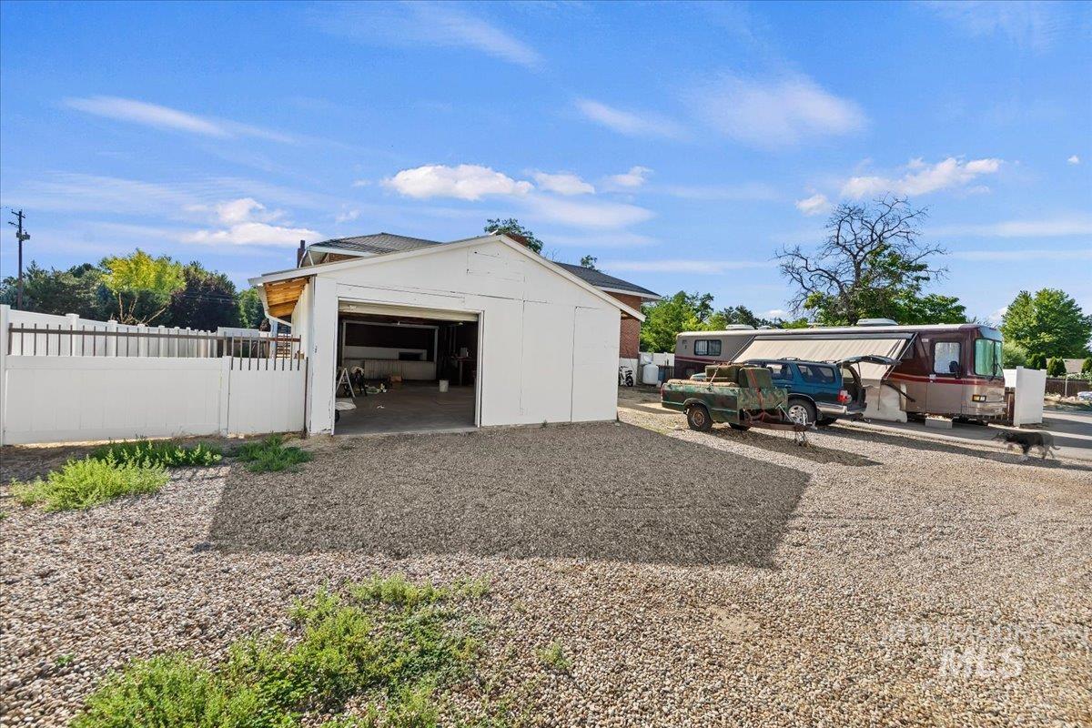 2160 South Five Mile Road Boise, ID 83709 - Photo 36 of 41 Detached garage with open bay door and gravel parking area