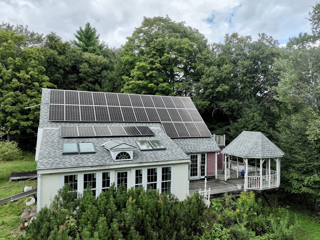 302 Number 9 Road Heath, MA 01367 - Photo 5 of 31 a aerial view of a house with large trees and plants
