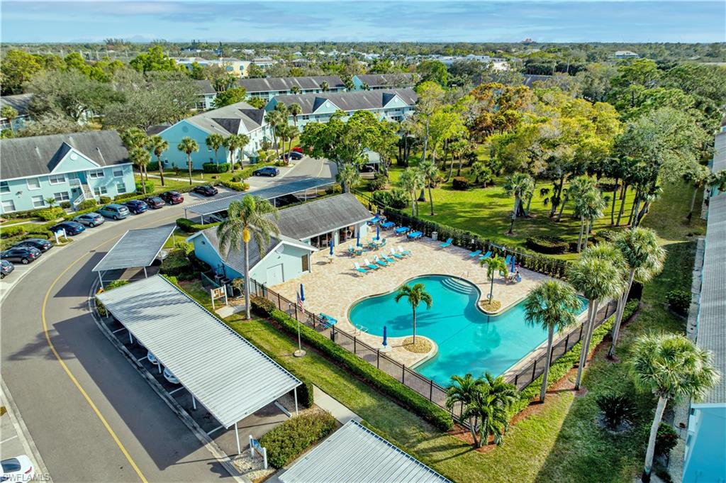 137 Wading Bird Circle, Unit F101 Naples, FL 34110 - Photo 11 of 16 an aerial view of a house with yard swimming pool and outdoor seating