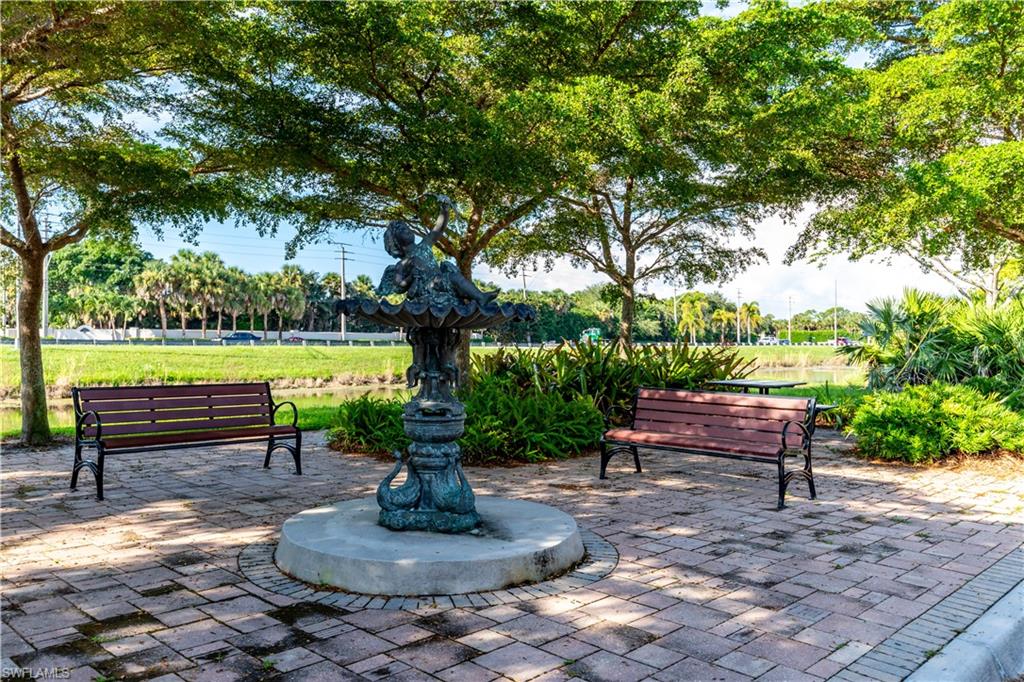 137 Wading Bird Circle, Unit F101 Naples, FL 34110 - Photo 16 of 16 a view of a garden with sitting area