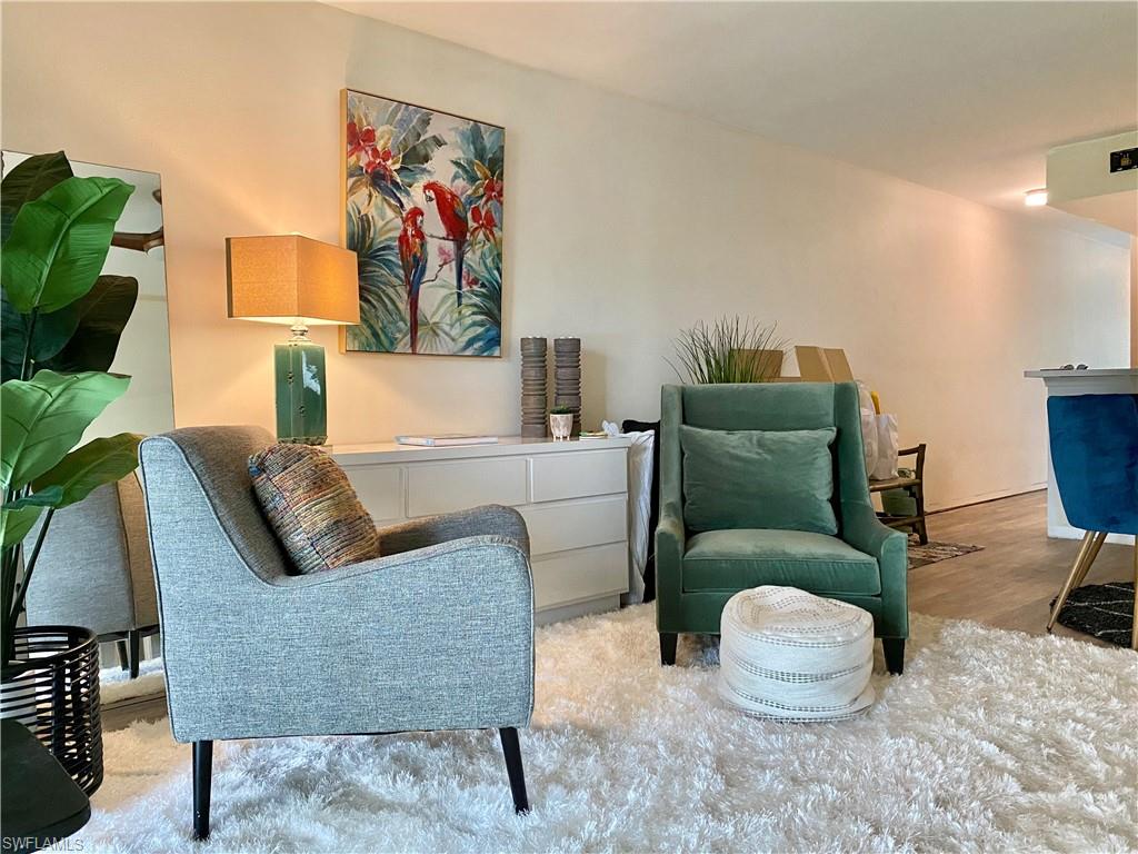 137 Wading Bird Circle, Unit F101 Naples, FL 34110 - Photo 4 of 16 a living room with furniture and a couch