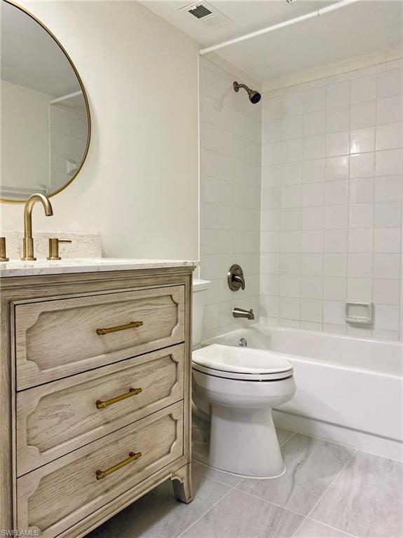 137 Wading Bird Circle, Unit F101 Naples, FL 34110 - Photo 8 of 16 a bathroom with a toilet sink and mirror