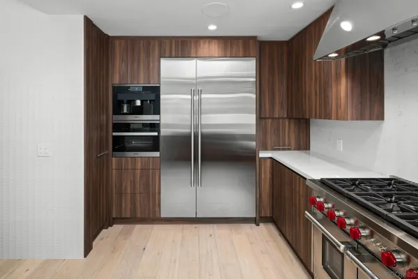 a kitchen with kitchen island a counter space a sink and a refrigerator