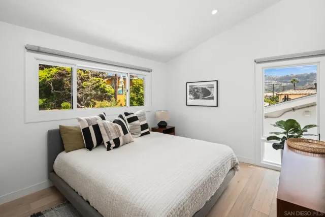 a bedroom with a large bed and a window