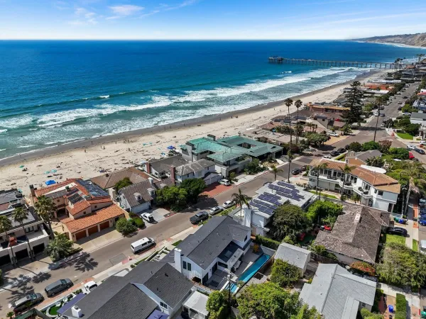 an aerial view of residential building and ocean