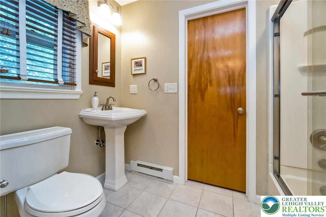 1328 Russett Road Allentown, PA 18104 - Photo 31 of 46 A compact bathroom featuring a classic pedestal sink, easy-care tile flooring, and a convenient shower.