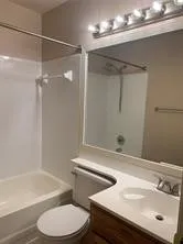 a bathroom with a sink toilet and shower