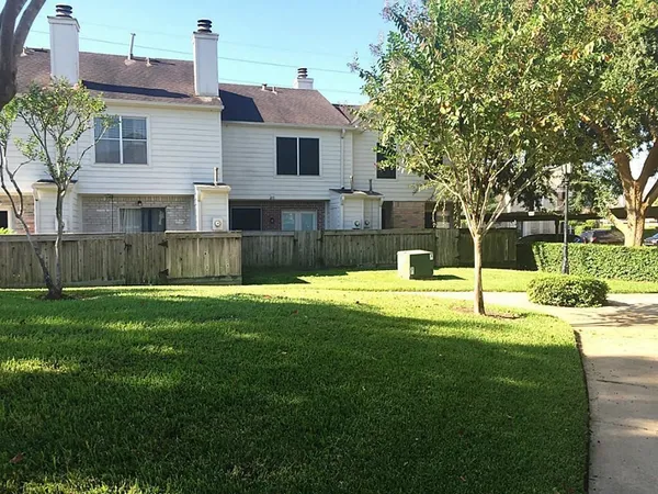 a view of a house with a backyard