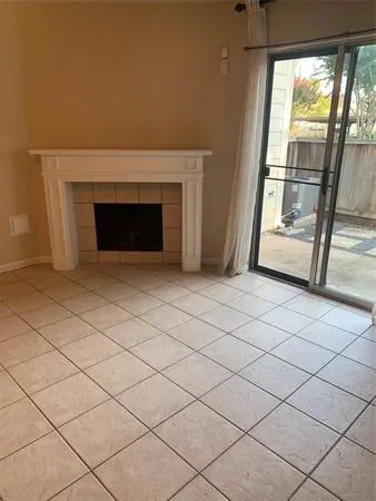 a view of an empty room with a fireplace