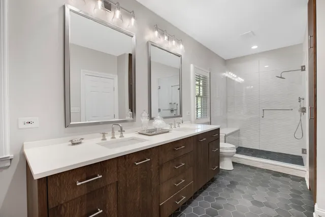 a bathroom with a sink double vanity and a mirror