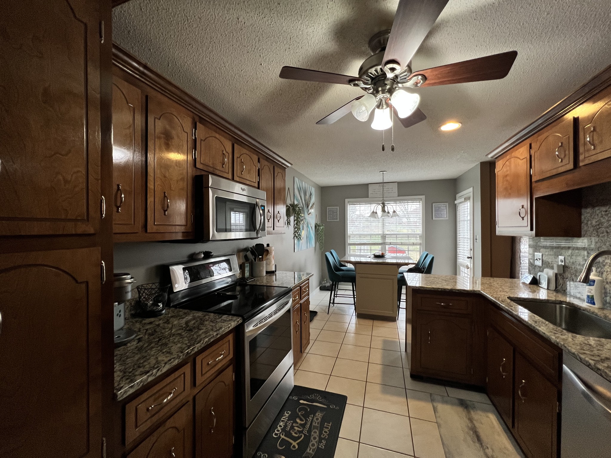 3366 Brownsville Road Clarksville, TN 37043 - Photo 3 of 23 a kitchen with stainless steel appliances granite countertop a sink dishwasher stove and refrigerator with wooden floor