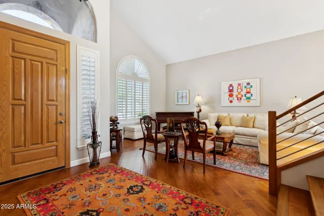 a living room with furniture rug and wooden floor