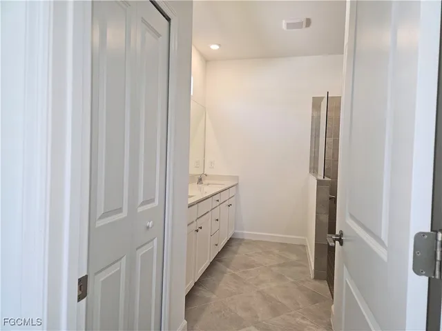 a bathroom with a double vanity sink and mirror