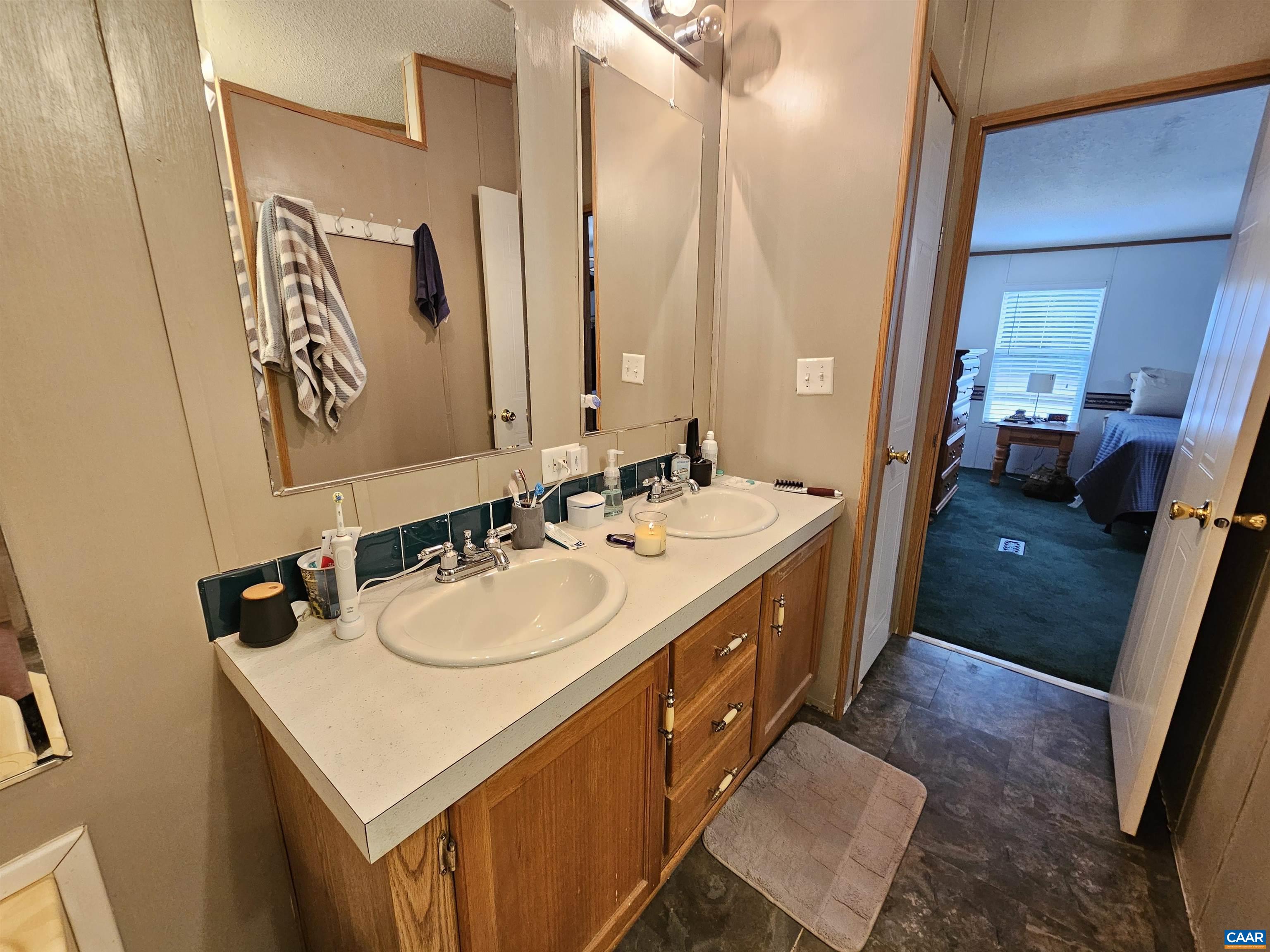 981 Scotts Bottom Road Dillwyn, VA 23936 - Photo 17 of 62 a bathroom with a double vanity sink and a mirror