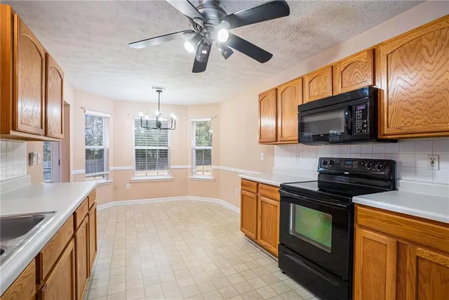 a kitchen with stainless steel appliances granite countertop a sink and stove top oven