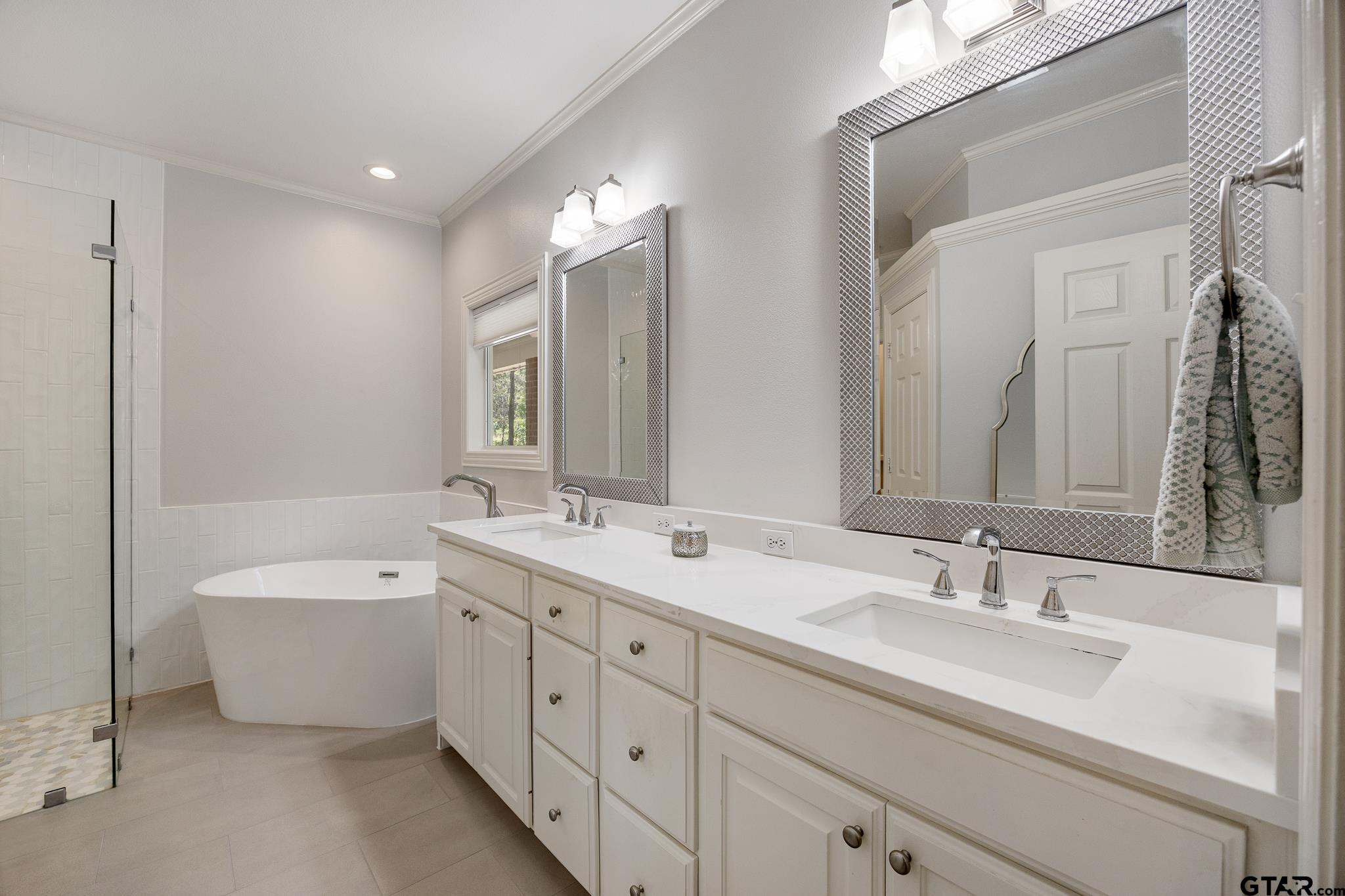 18076 Deer Trail Flint, TX 75762 - Photo 16 of 46 a spacious bathroom with a double vanity sink mirror double and bathtub