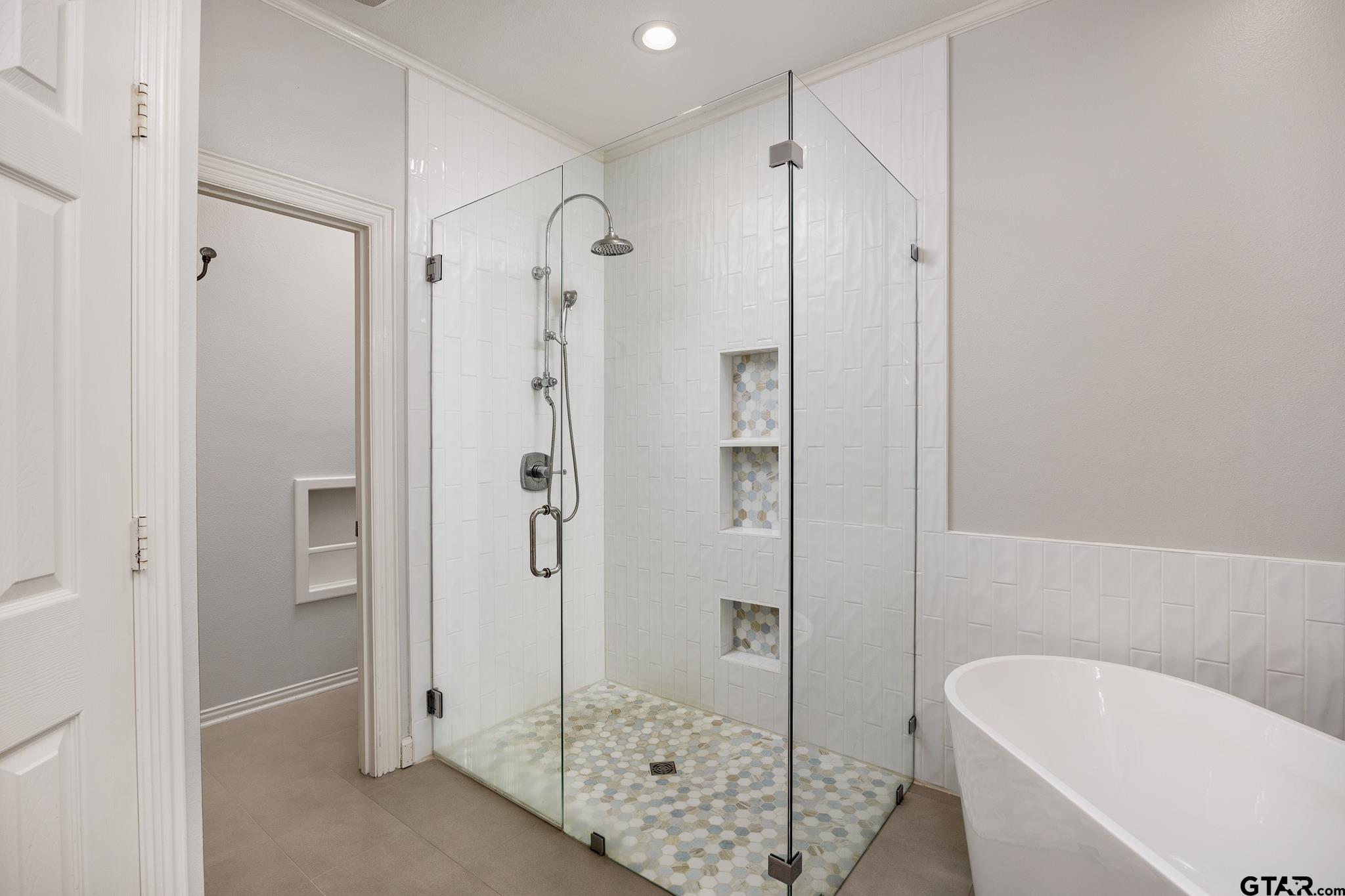 18076 Deer Trail Flint, TX 75762 - Photo 17 of 46 a bathroom with a shower and a bath tub
