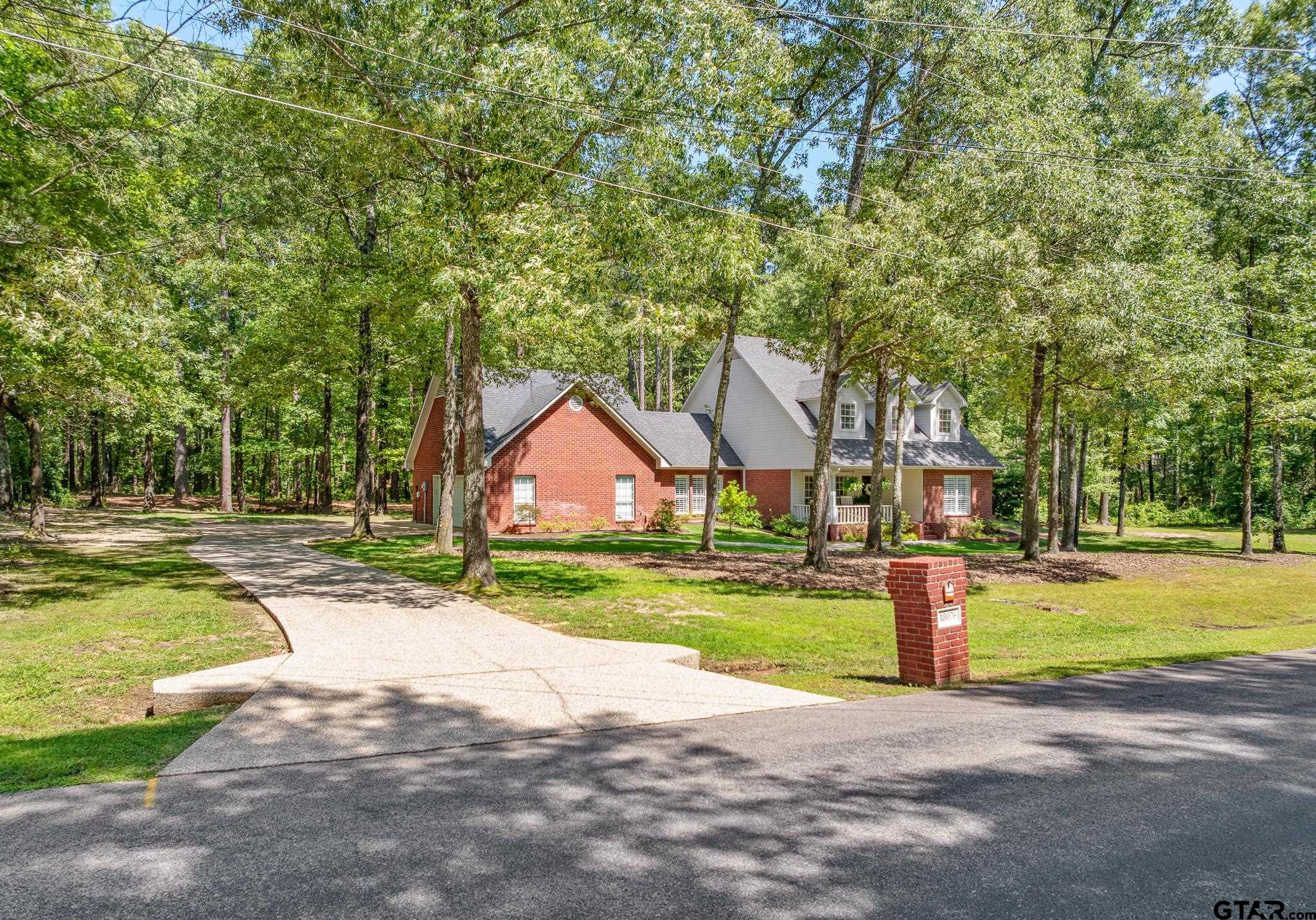 18076 Deer Trail Flint, TX 75762 - Photo 2 of 46 a front view of a house with a yard and trees