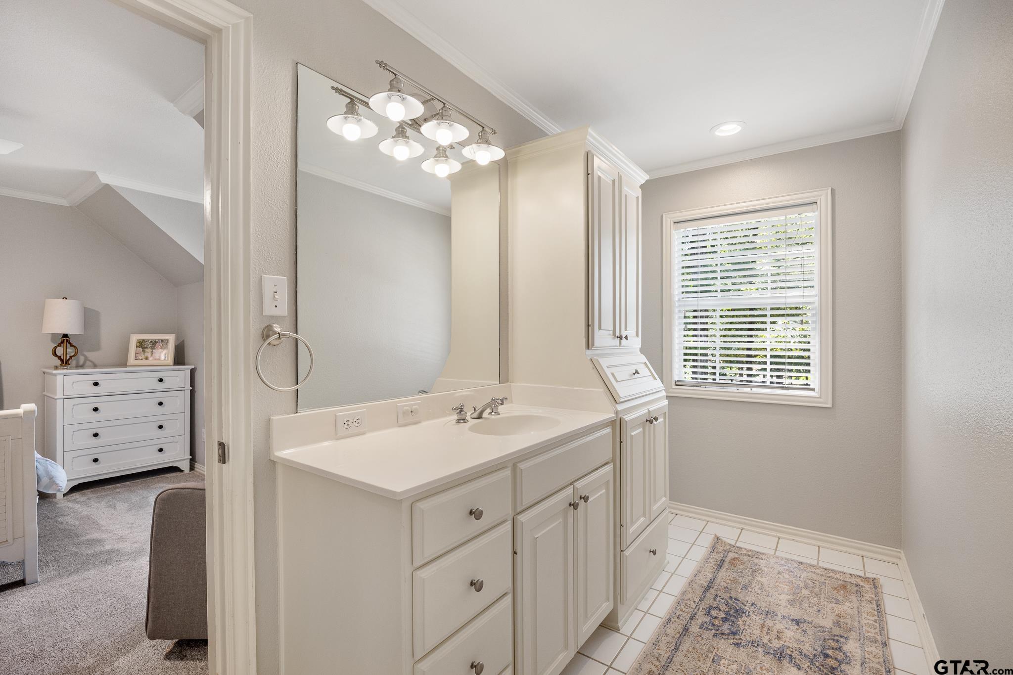 18076 Deer Trail Flint, TX 75762 - Photo 31 of 46 a bathroom with a sink a vanity and a mirror