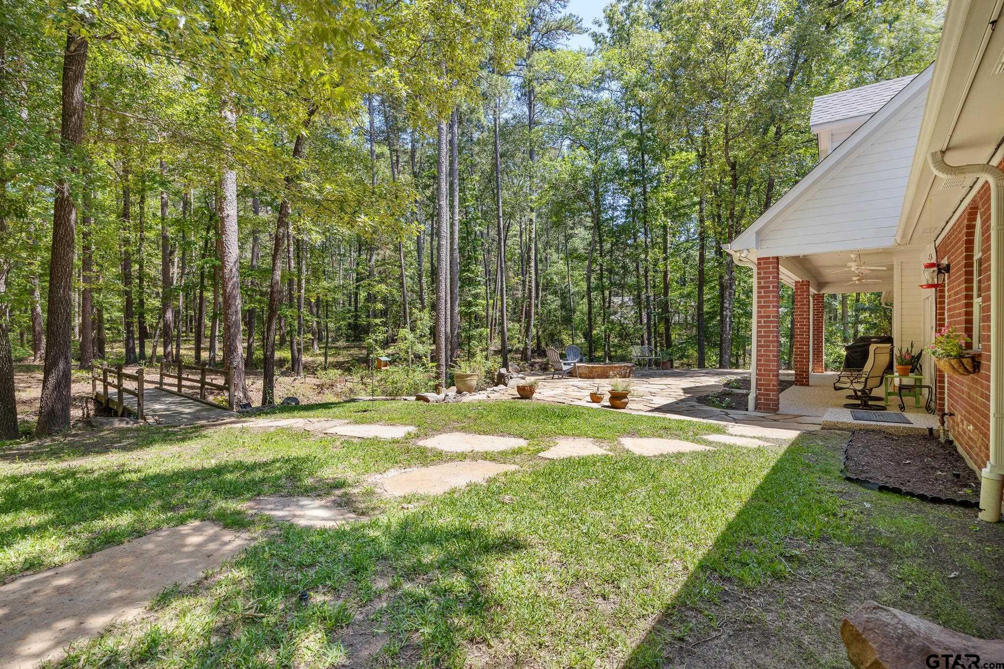 18076 Deer Trail Flint, TX 75762 - Photo 35 of 46 a view of swimming pool with lawn chairs and large trees