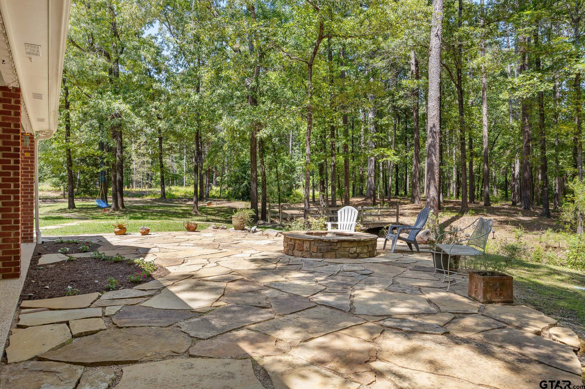 18076 Deer Trail Flint, TX 75762 - Photo 38 of 46 a view of backyard with a table and chairs