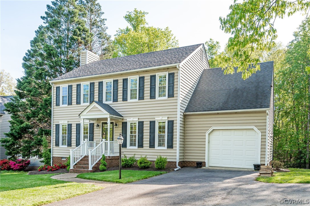 5427 Standing Oak Road Midlothian, VA 23112 - Photo 2 of 33 a front view of a house with a yard and garage