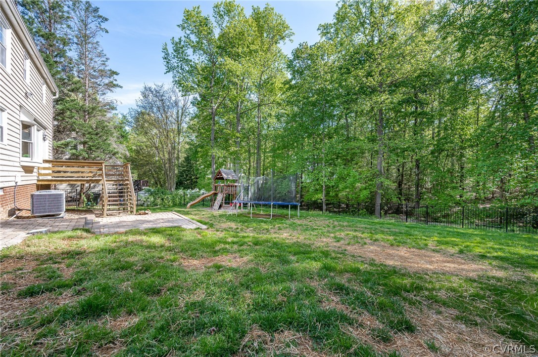 5427 Standing Oak Road Midlothian, VA 23112 - Photo 4 of 33 a view of a backyard with table and chairs and large trees