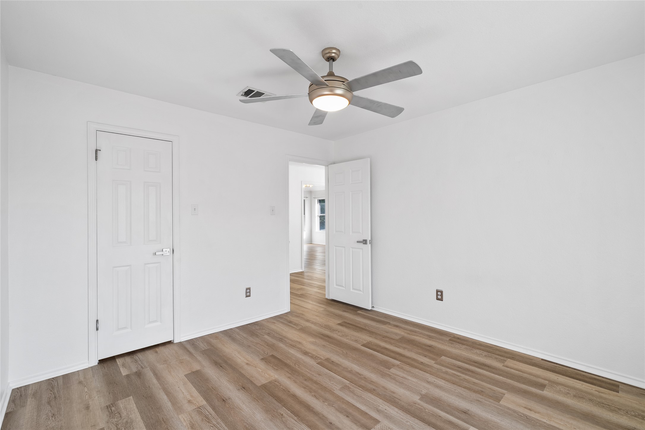 206 River Down Road Georgetown, TX 78628 - Photo 26 of 39 Room featuring wood-finish flooring, white walls, and a ceiling fan with integrated lighting