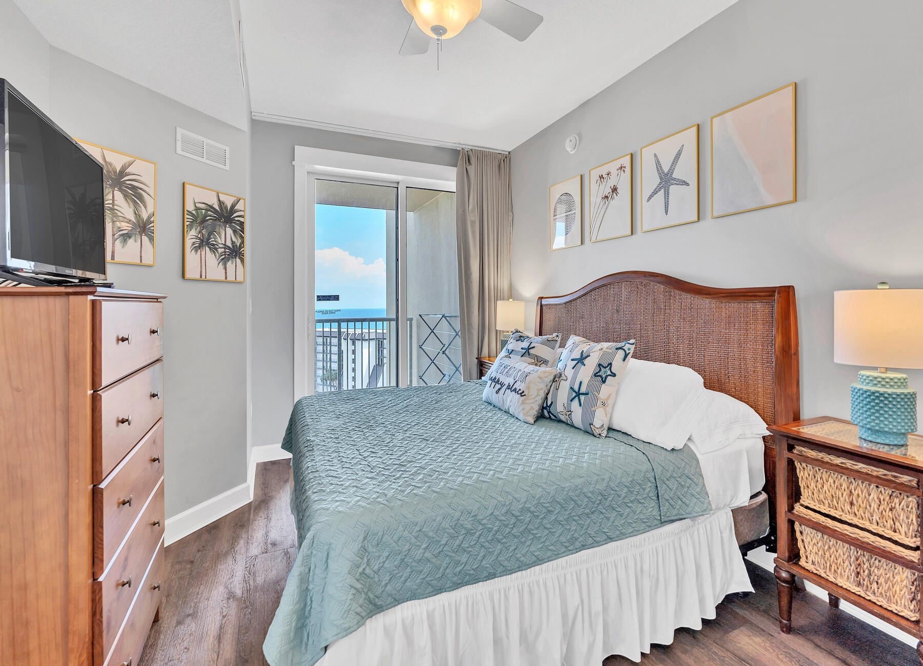 11800 Front Beach Road, Unit 2408 Panama City Beach, FL 32407 - Photo 11 of 42 a bedroom with a bed and flat screen tv